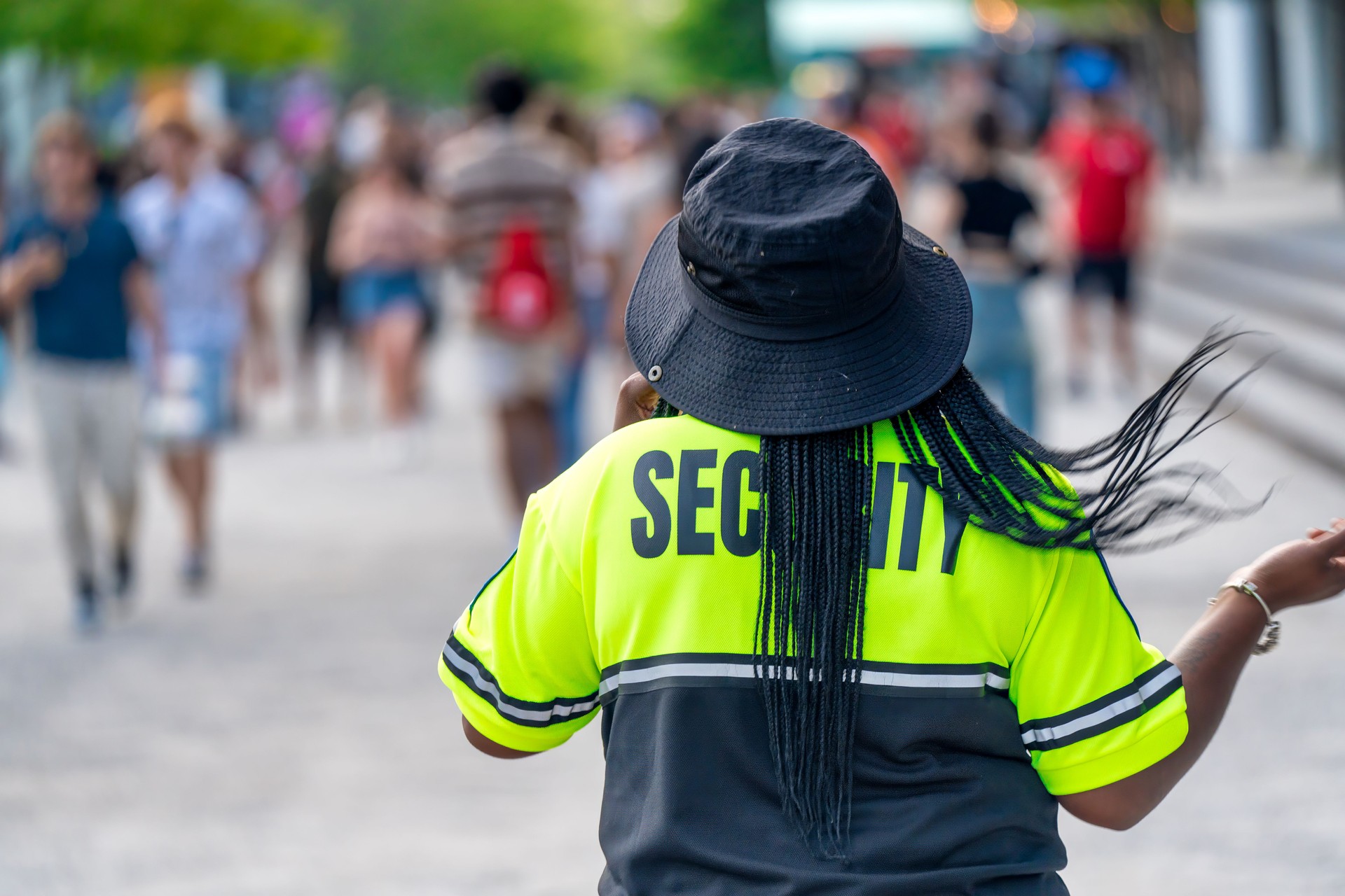 Security officer controlling crowd of people