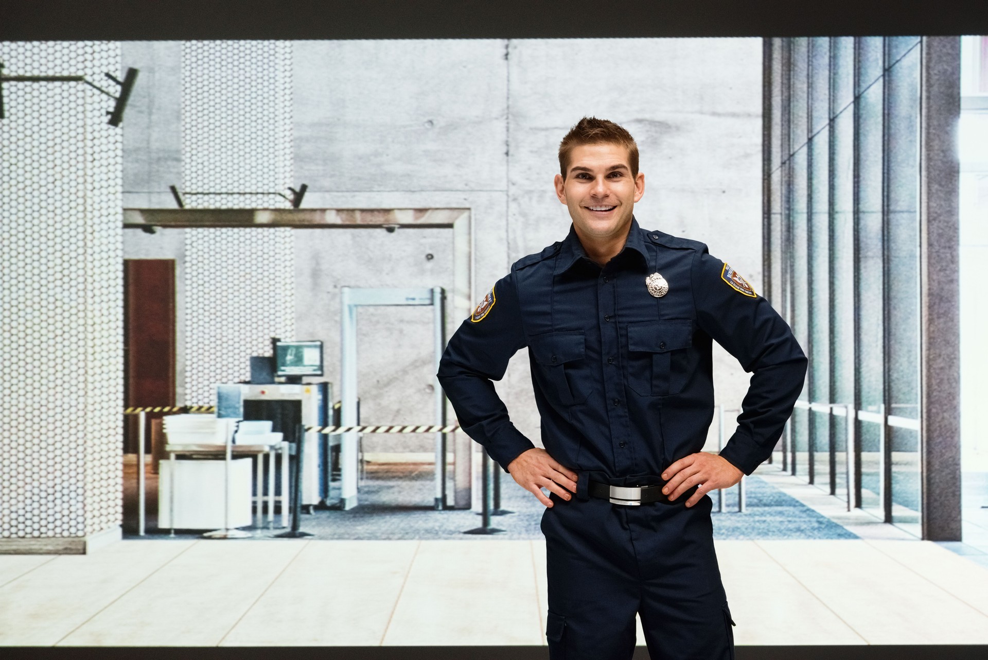 Smiling security guard standing indoors