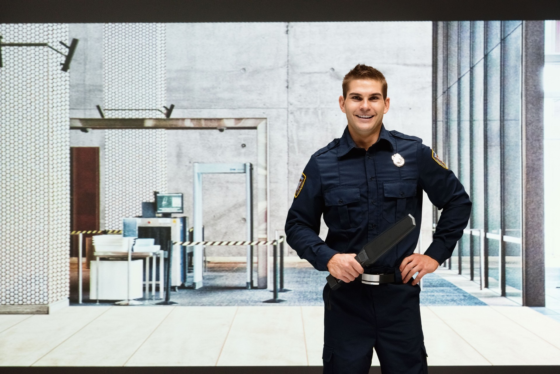 Smiling security guard standing indoors