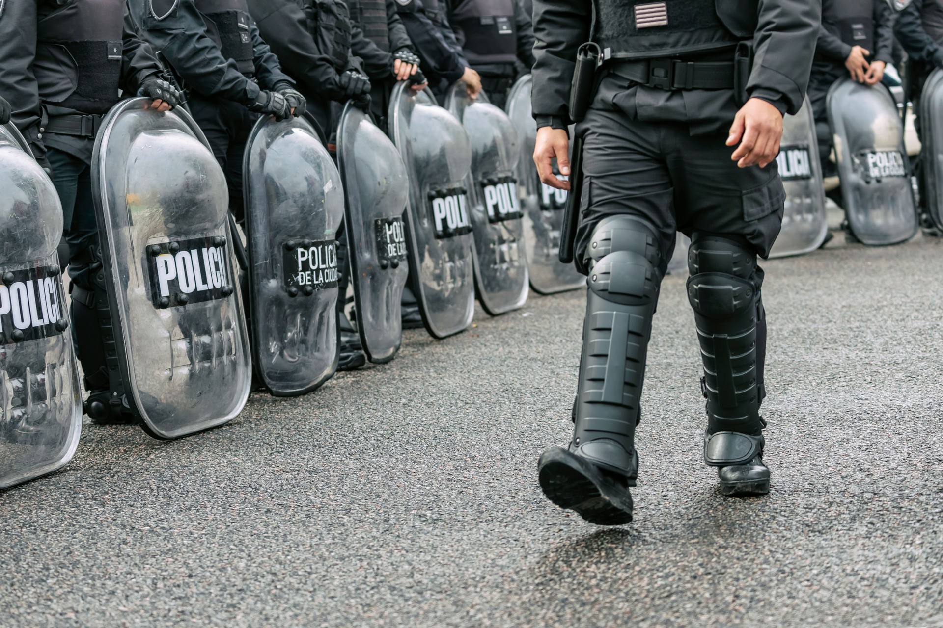 Police officers on duty with shields during street protest